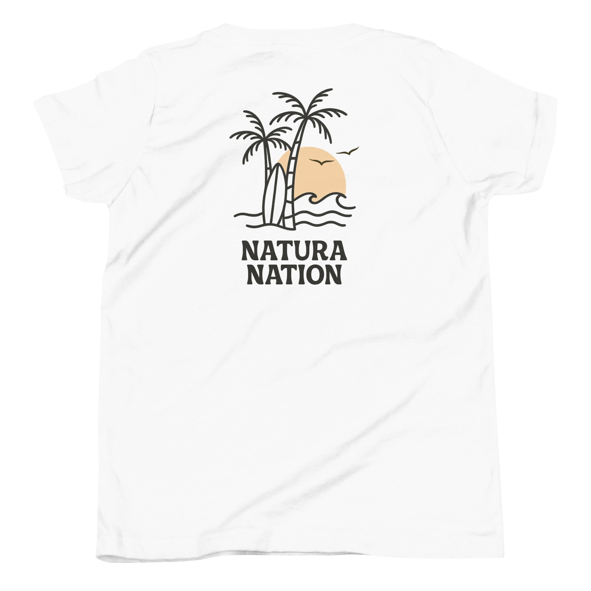 A white short-sleeve teen t-shirt for youth with a graphic on the back showing two palm trees, a peach-colored sun, waves, surf board and the text 'NATURA NATION' in black. The t-shirt is displayed flat against a white background. Made for kids who love the sea and the ocean.