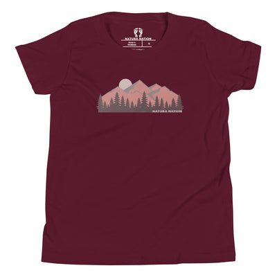 Kids mountain t-shirt with majestic peaks on the front. A maroon short-sleeve t-shirt with a stylized mountain and pine tree graphic on the chest, featuring the 'Natura Nation' logo printed inside the collar.
