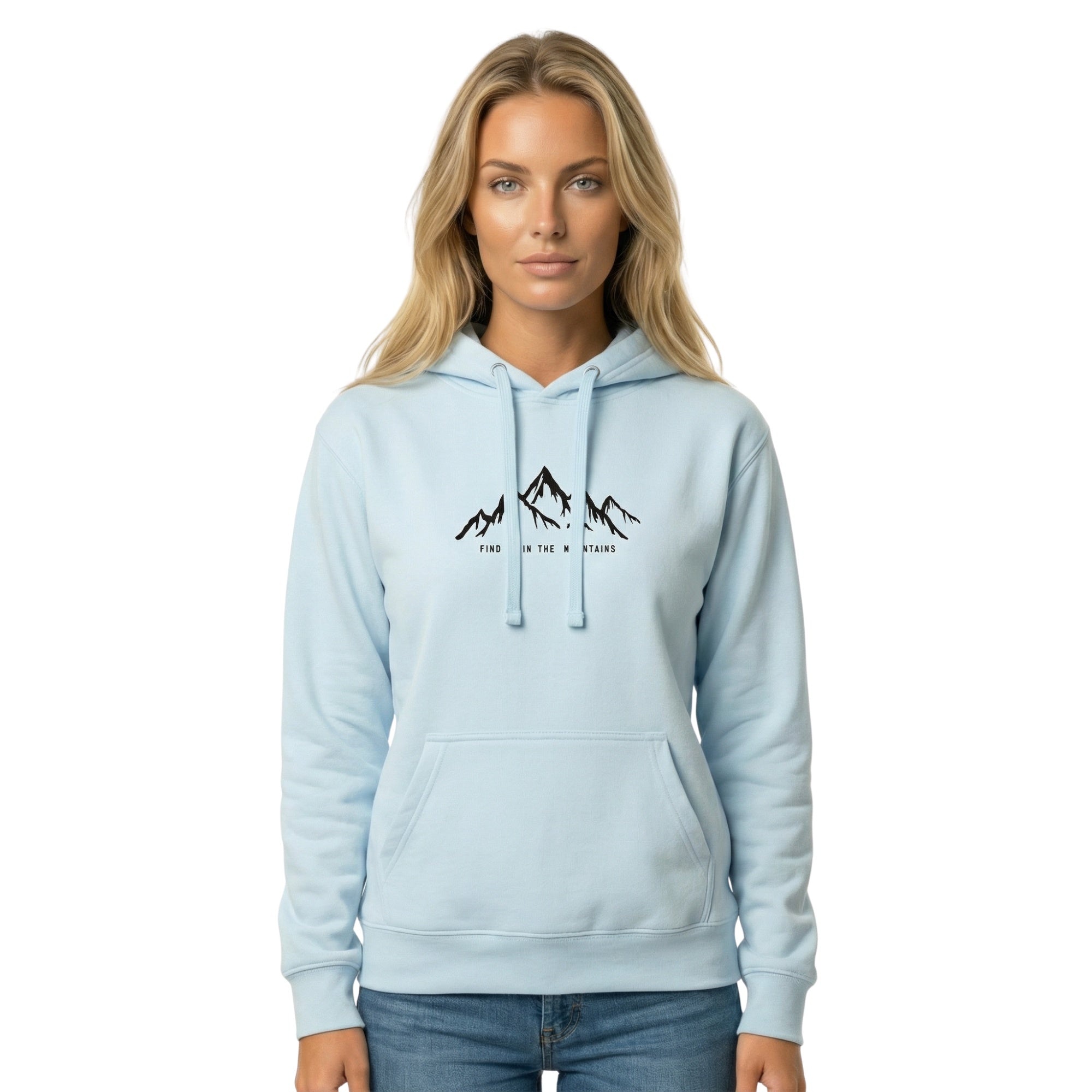 A female model wearing a Blue Sky Pullover mountain hoodie featuring the 'Find Me In The Mountains' design. A vibrant Mountain Hoodie for essential nature clothing made by Natura Nation.