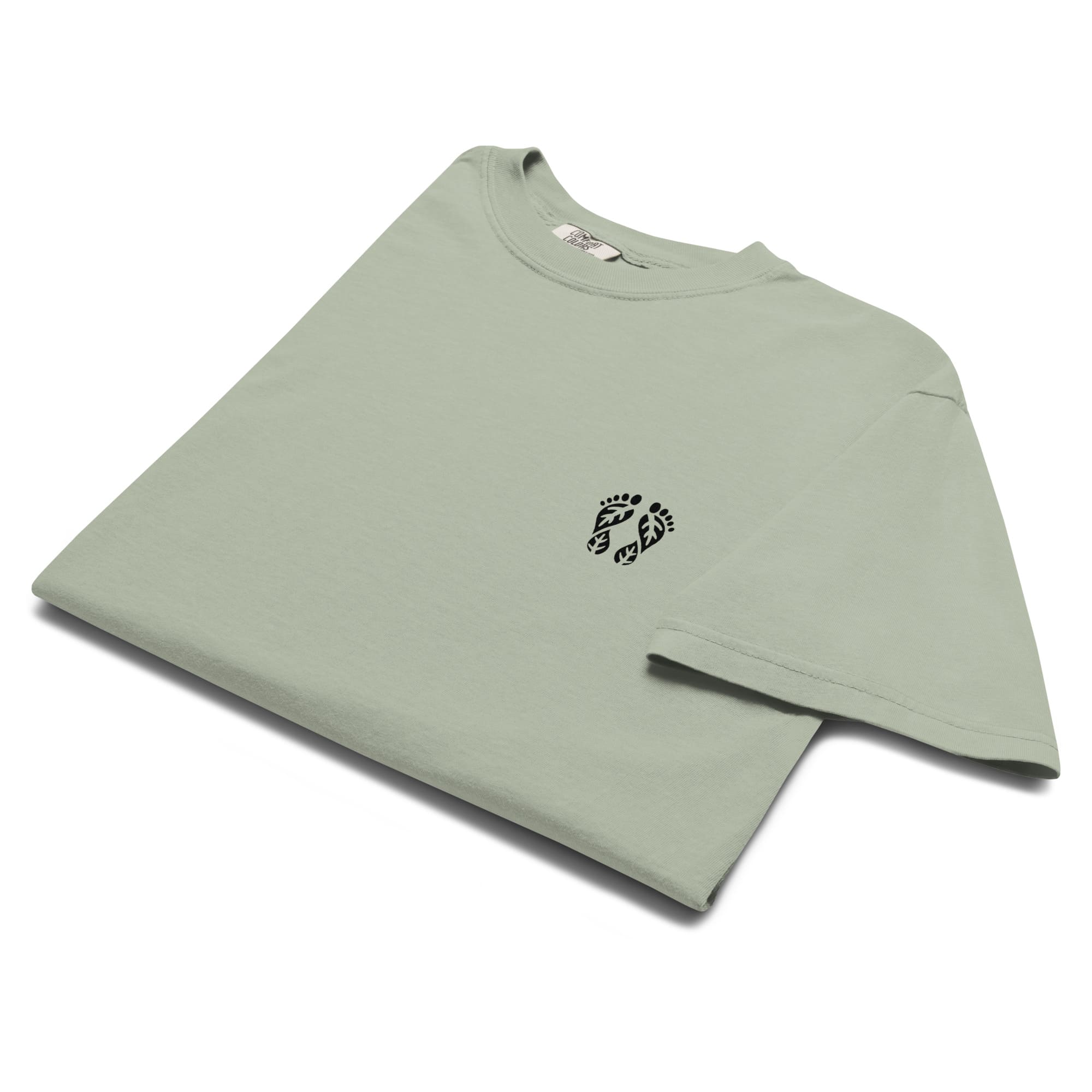 A bay-colored nature T-shirt featuring the 'Natura's Footprints' design. A light green nature clothing piece for calm, expansive views. Made by Natura Nation for nature lovers.