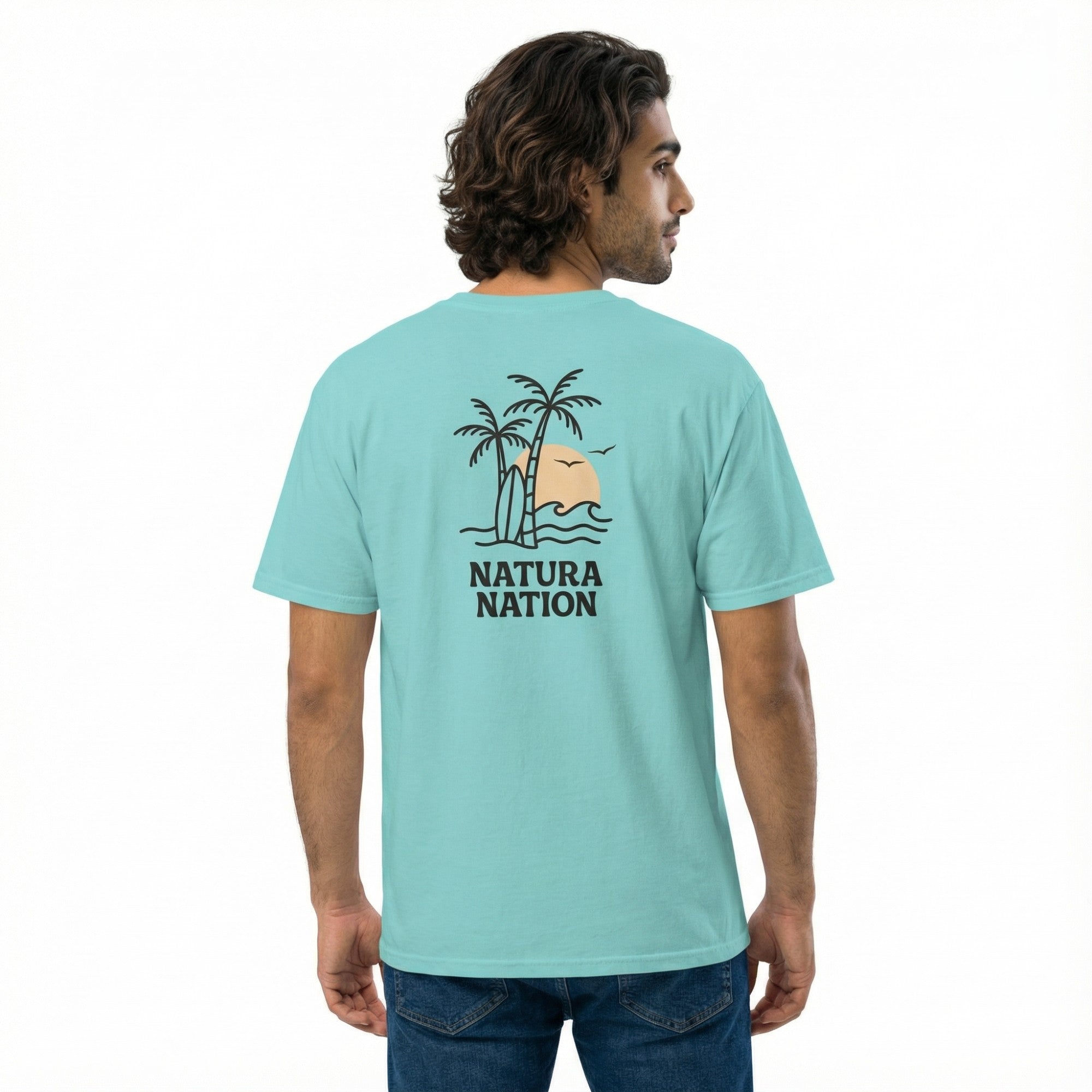 A man wearing a Lagoon Blue Ocean T-Shirt featuring the 'Tropical Dreams' design. A vibrant Ocean Clothing piece reflecting clear waters by Natura Nation.