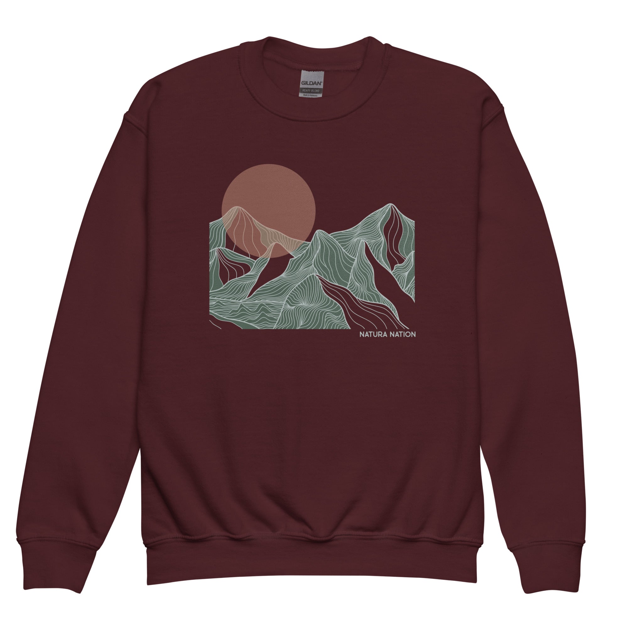 A crewneck sweatshirt in maroon with a graphic print of stylized mountains and a sun in muted green, beige, and brown tones. The text 'NATURA NATION' is printed on the lower right of the graphic. Kids graphic mountain sweatshirt featuring a sunset glow for teens and youth.