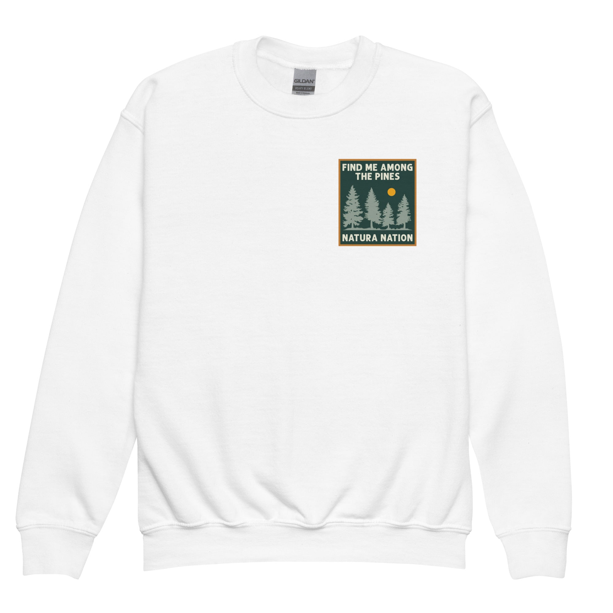 A white crewneck sweatshirt with a small square graphic on the left chest depicting pine trees and a sun with the text 'FIND ME AMONG THE PINES' and 'NATURA NATION'. Youth graphic pine sweatshirt for kids who love the forest and the outdoors.