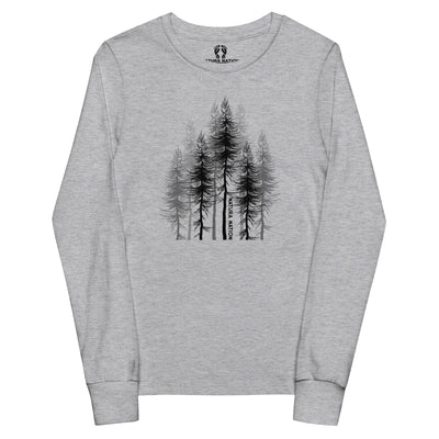Youth pine trees long-sleeved t-shirt, front view. A light athletic heather gray long-sleeve t-shirt with a black graphic of pine trees on the chest, featuring the brand name 'Natura Nation' printed vertically on one of the tree trunks.